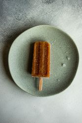 Fruity ice cream pop on ceramic plate
