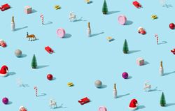 Christmas pattern made with festive items in rows like trees, champagne, presents, and reindeers