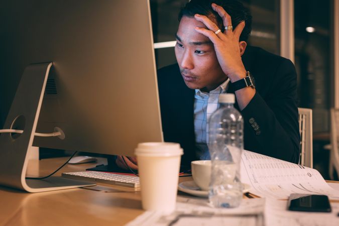 Entrepreneur looking tensed while working late in office