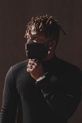 Thoughtful Black man in black face mask