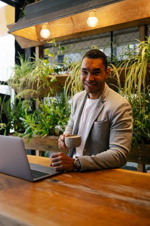 Man working on laptop at cafeteria