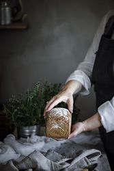 Fresh bread on napkin near tomatoes jam