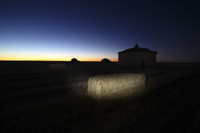 Aged house in rural countryside under starry sky