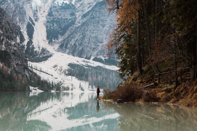 Man delighting in views near lake and mountains