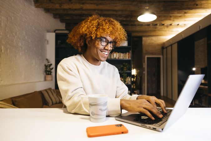 Young man using a laptop at home.