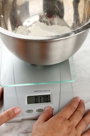 Female Hand Preparing Baking Scale and Flour