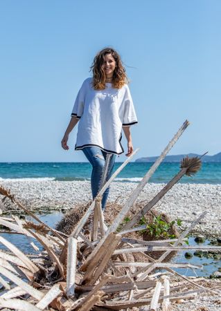 Young woman walking near dried plants