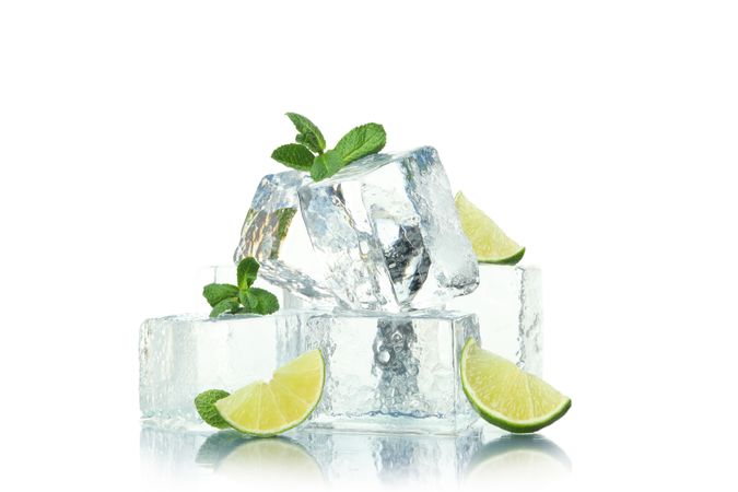 Stack of ice cubes with slices of lime, and mint leaves