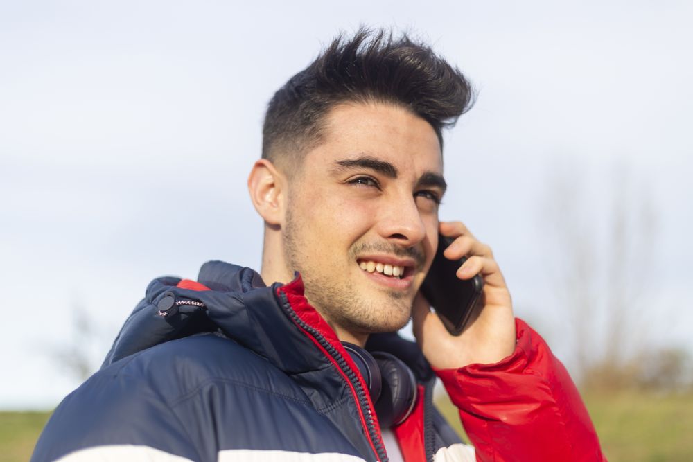 Man speaking on a smartphone in park