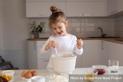 Young girl in light shirt making cupcake in the kitchen 49pZQ5