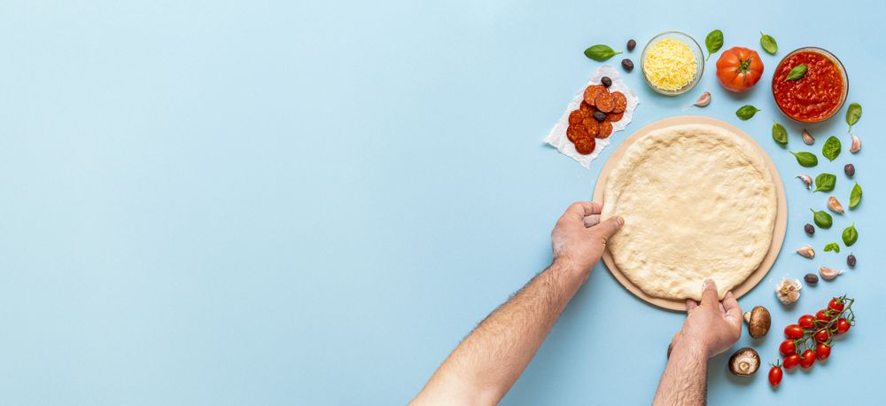Stretching pizza dough on a baking stone