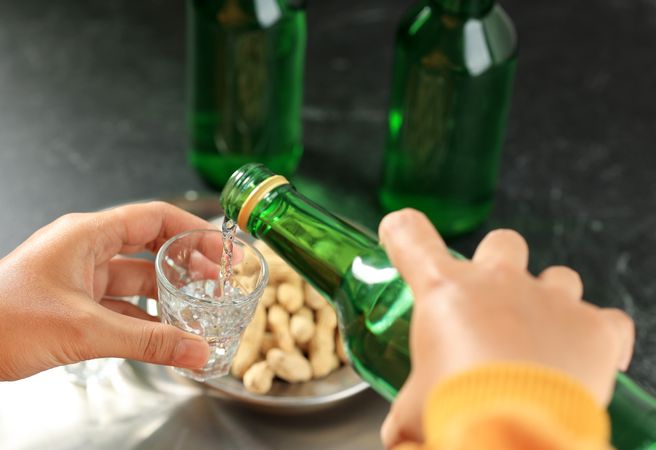 Pouring Soju Water Korean Alcohol to Small Glass, Drinking Lifestyle