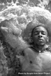 Grayscale portrait of topless man laying in water 5qKLEb