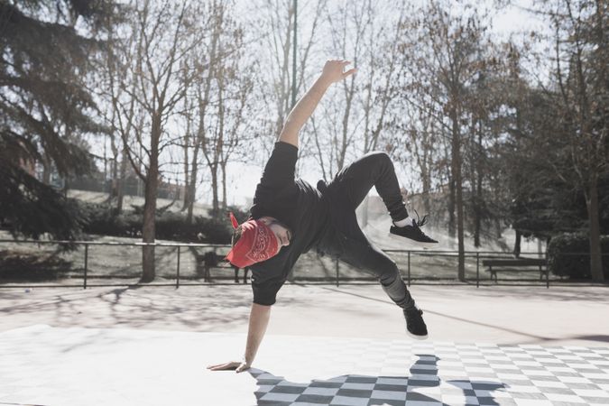 Man dancing break dance in park