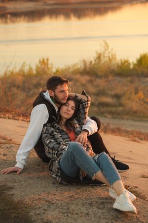 Couple sitting dusk countryside