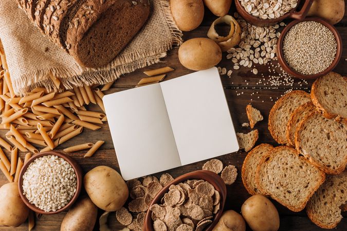 Wholegrain food and freshly baked rye bread on table