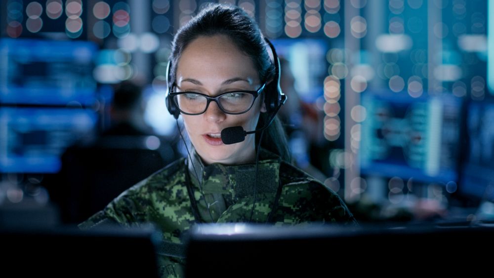 Female IT Engineer Works on Her Desktop Computer in Government Surveillance Agency.