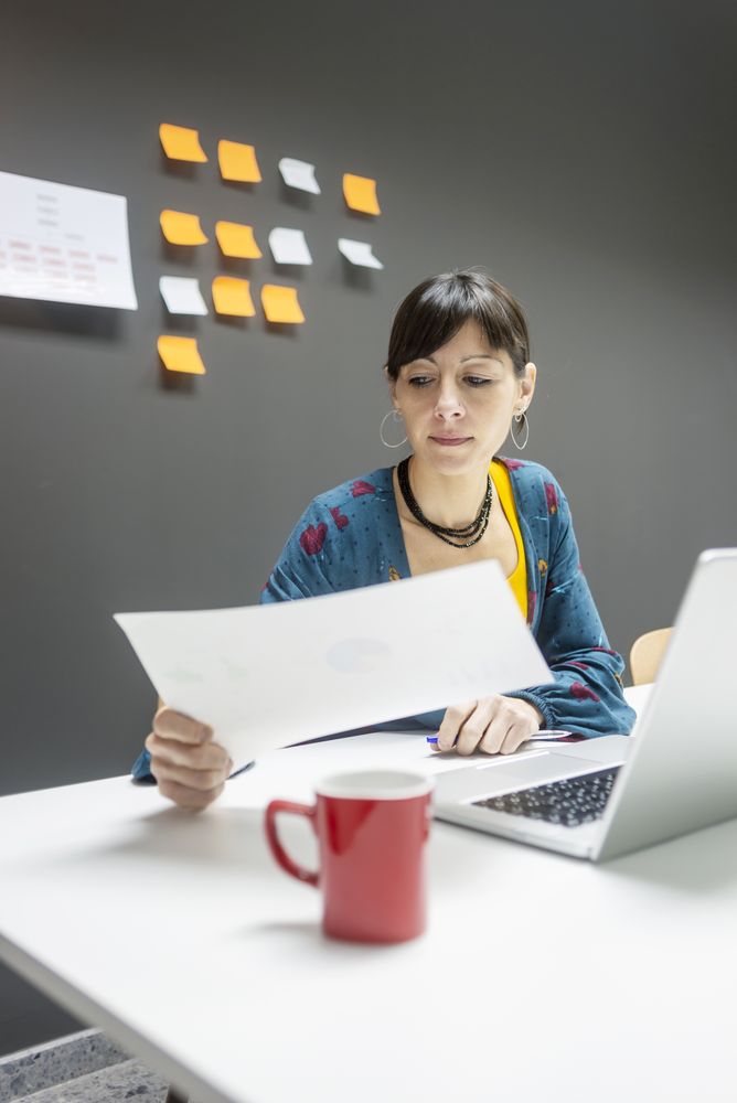 Smiling businesswoman working with documents