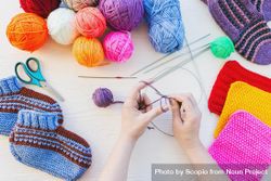 Woman knitting using colorful yarn 4B7rPb