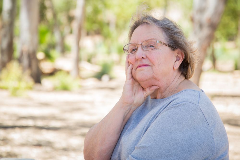 Upset Mature Woman Sitting Alone