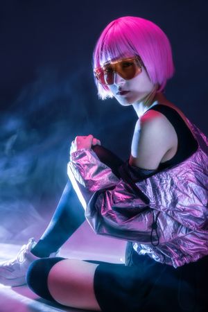 Woman sitting in sparkly silver jacket