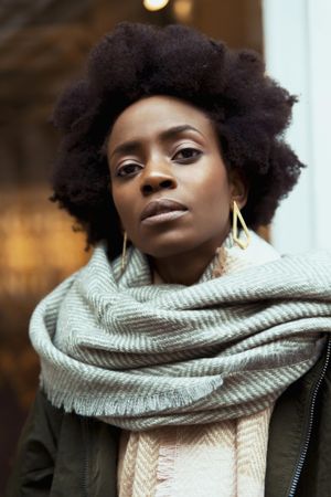 Portrait of Black woman wearing gray scarf