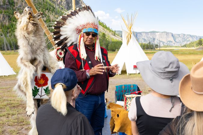 Montana, United States - August 17, 2022: Native man with tourists in Yellowstone National Park