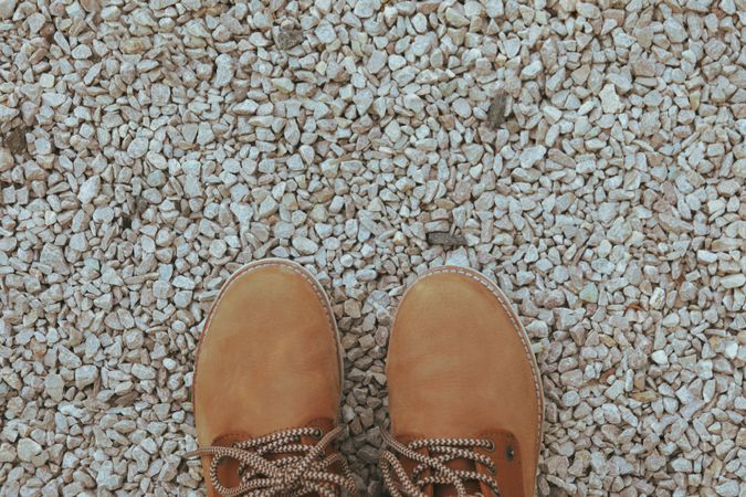 Boots on stones background, top view and space for text
