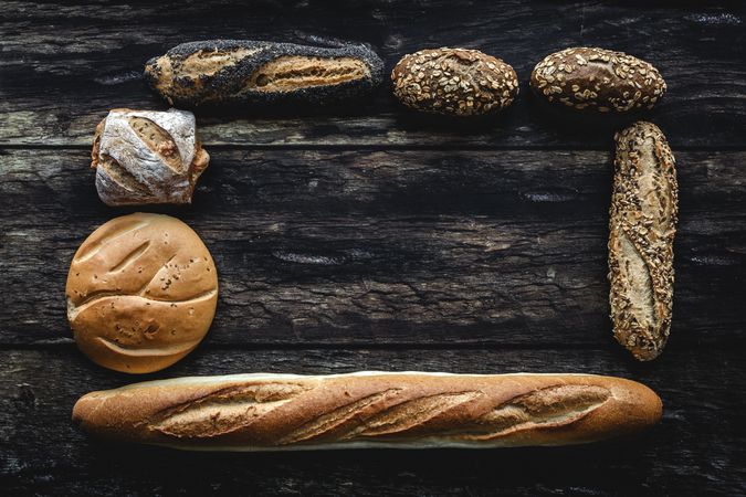 Assorted gold homemade bread on dark wood background