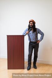 Man addressing the room next to a podium bYN7g0
