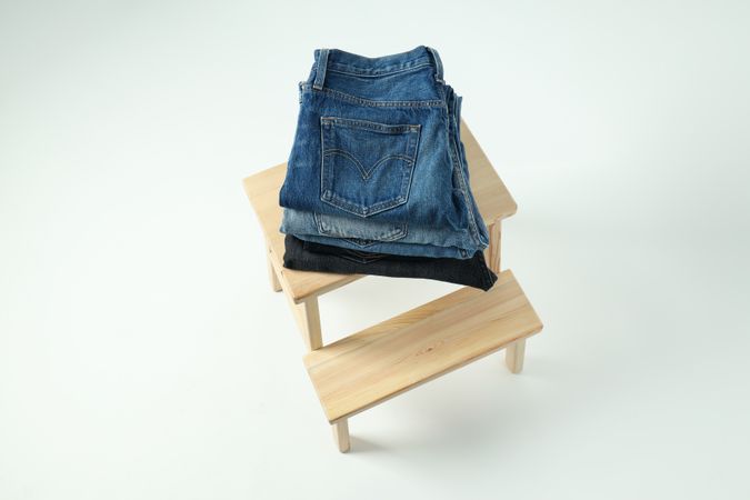 Folded jeans on a wooden chair