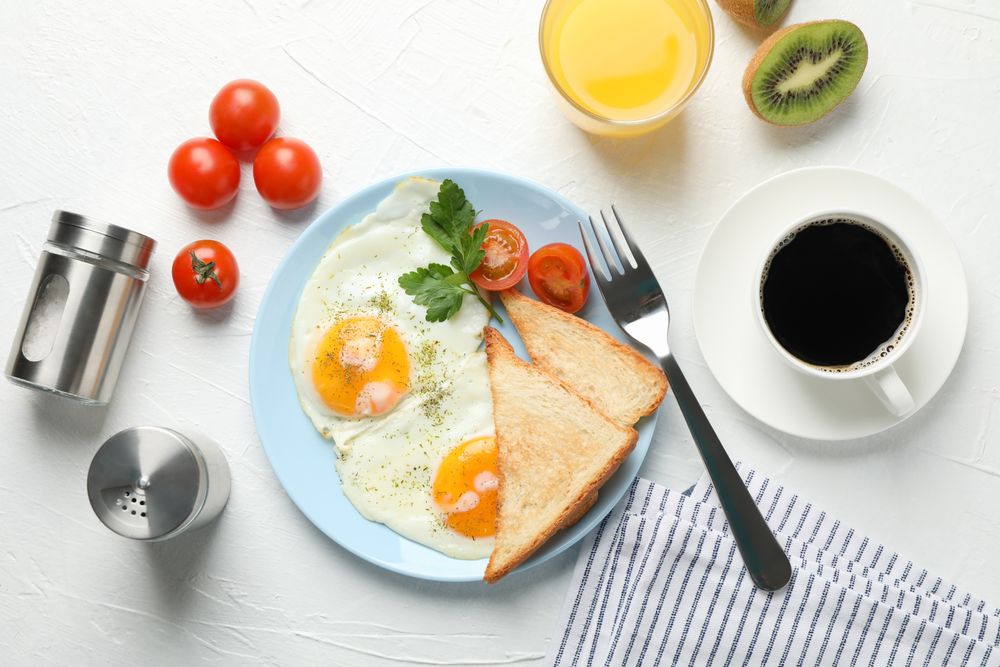 Top view of plate of fried eggs for breakfast on blue plate