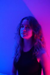 Portrait of teenage girl in purple lit room