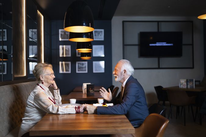 Mature man and woman on a date in a quiet restaurant