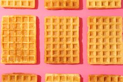 Flat lay composition with belgian waffles on color background