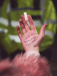 London, England, United Kingdom - March 16, 2021: Palm of hand with “She was walking home”