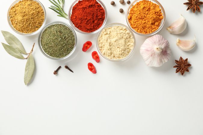 Top view of colorful spices arranged in bowls with copy space