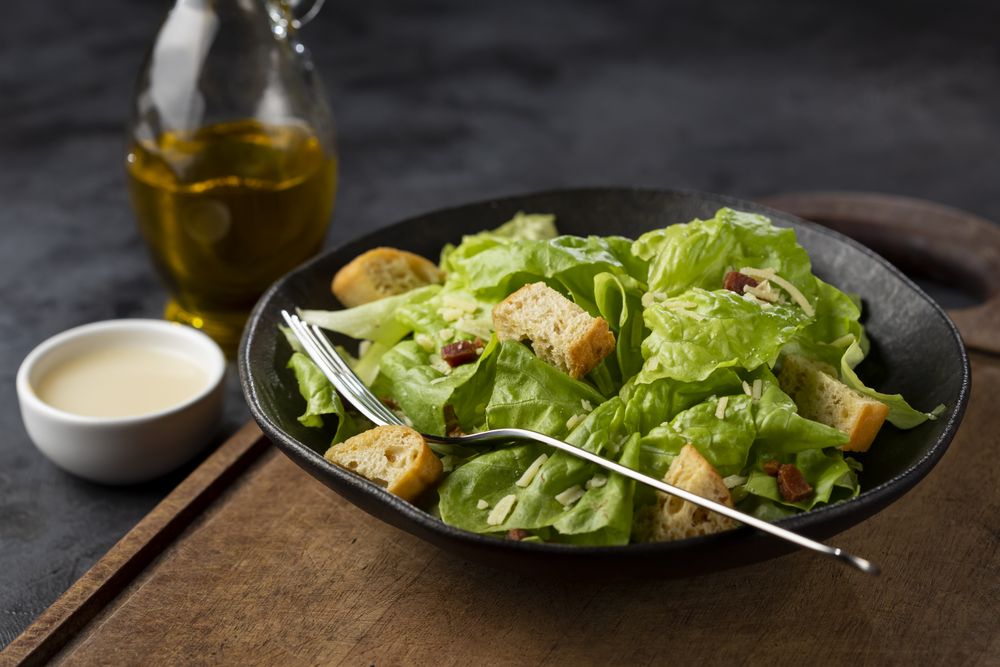 Caesar salad with croutons and bacon.