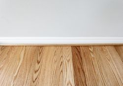 New red oak floor with trim against wall