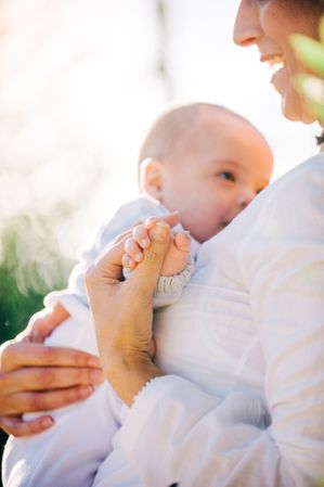 detail of the hands of a baby and his grandmother