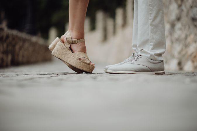 Romantic couple standing facing each other at summer street