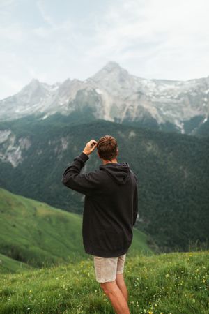 Anonymous male admiring view of mountain ridge