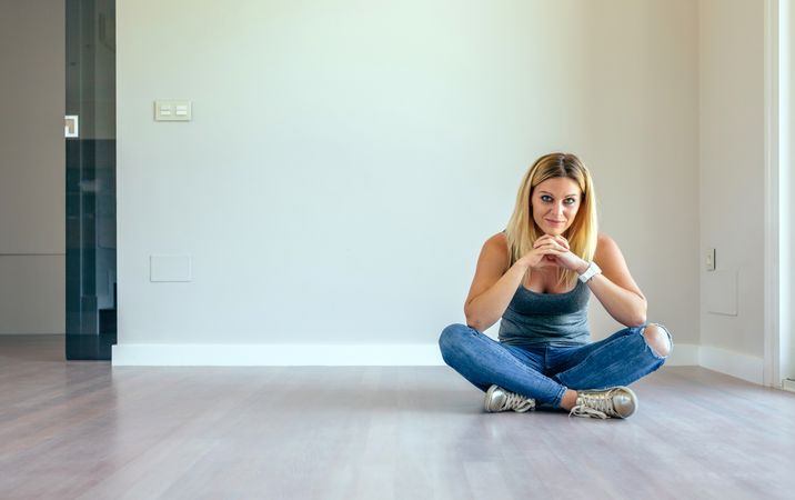 Thoughtful woman sitting in a living room