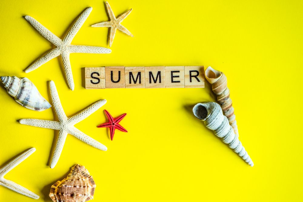 "Summer" on yellow background with sea shells