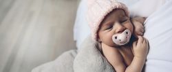 Baby girl with pacifier sleeping