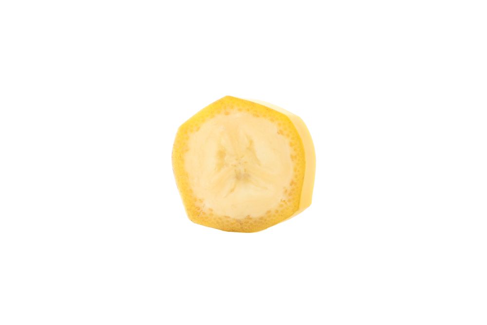 Slice of banana with peel on blank background