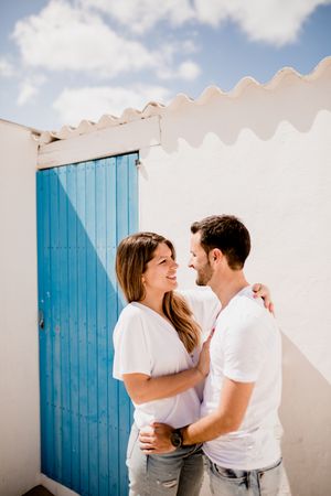 Loving couple cuddling near beach house