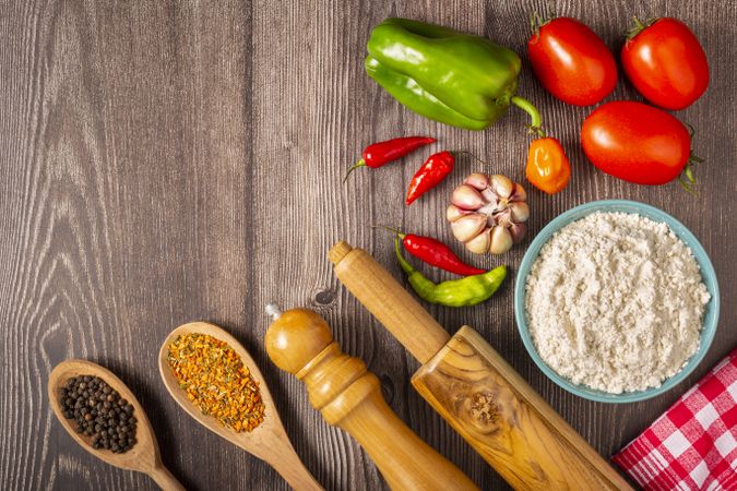 Wooden table with ingredients for pizza.