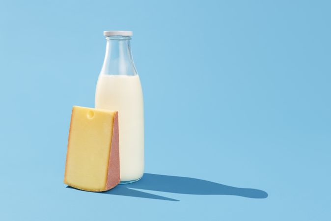 Milk and cheese on blue table