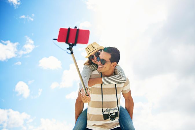 Shot looking up at sky while a couple takes a selfie